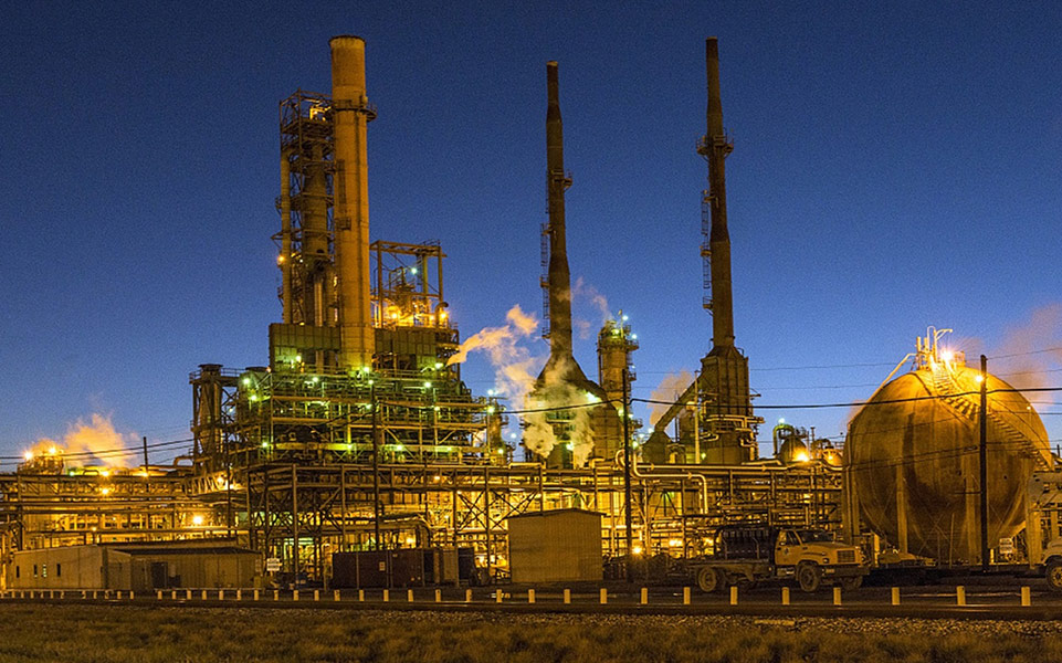 refinery stacks lit up after dark